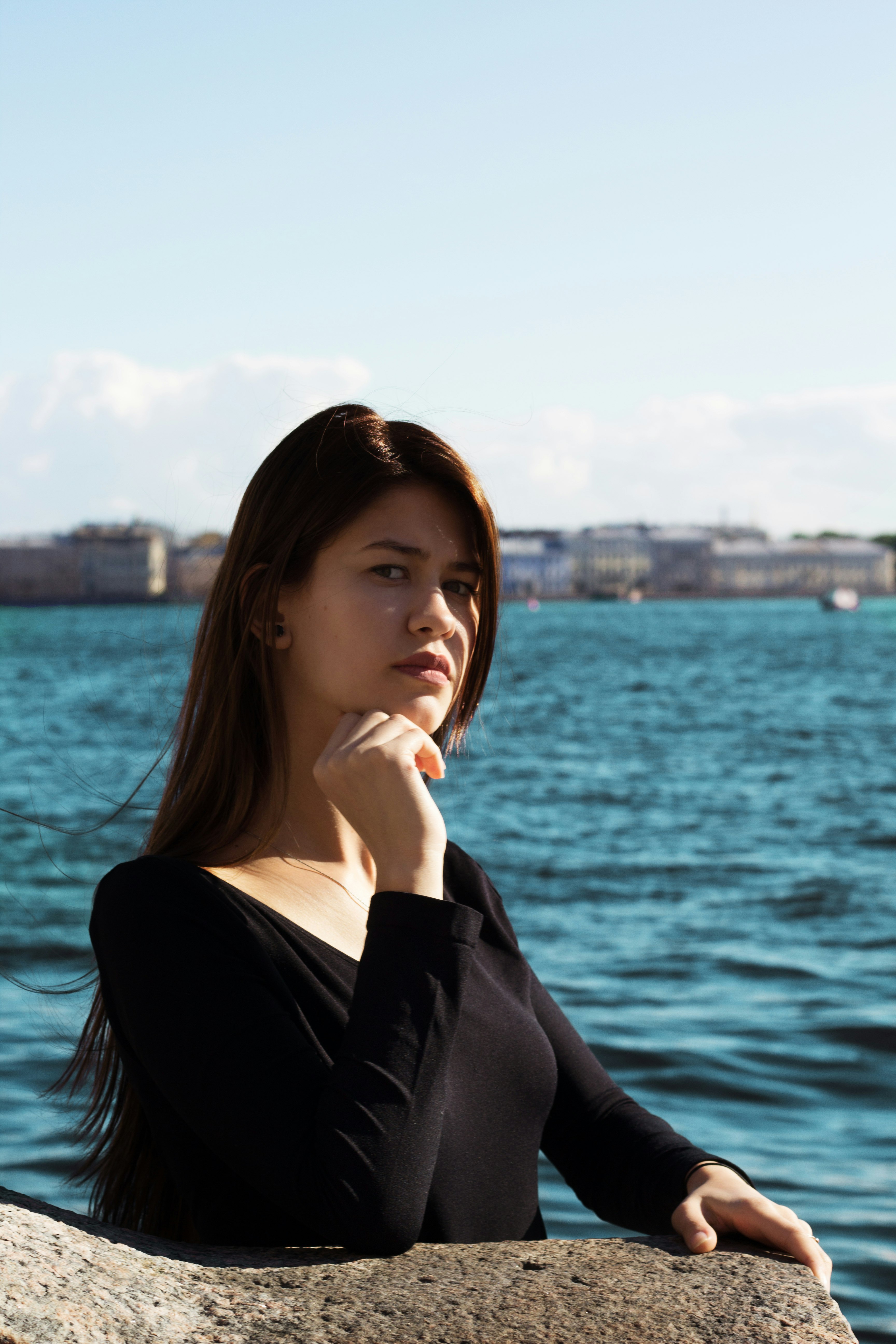 woman in black long sleeve shirt near body of water during daytime